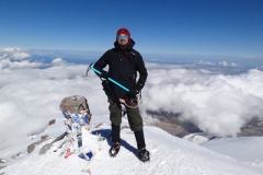 Ben S. on top of Mt. Elbrus wearing 40 Below K2 Superlight overboots